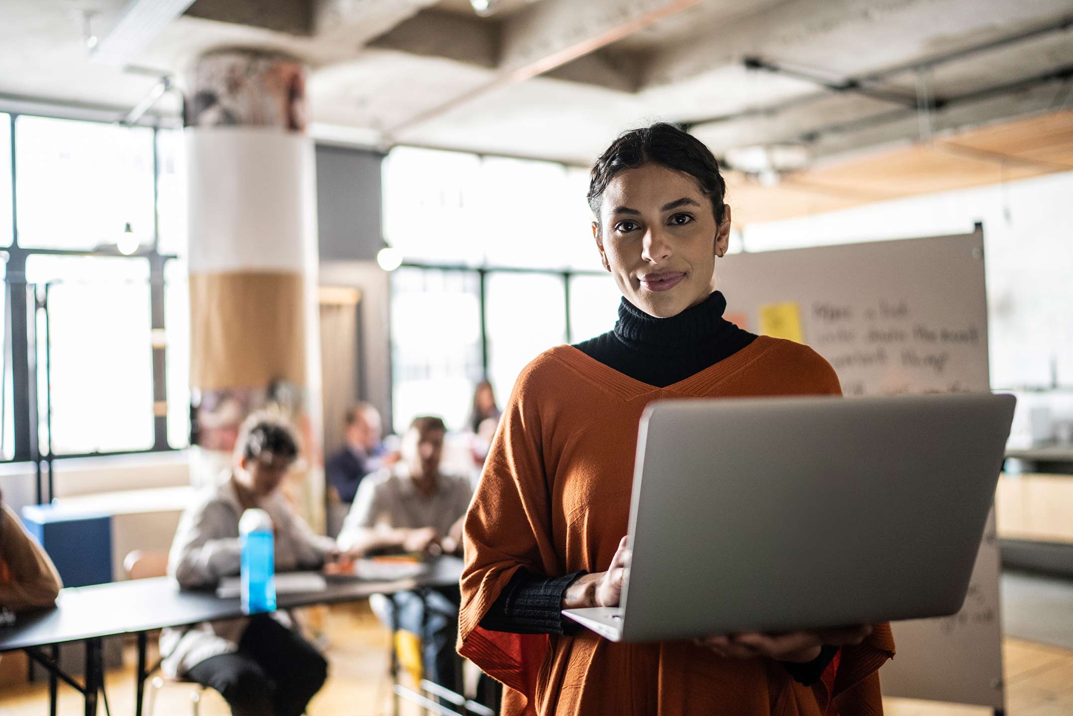 woman holding laptop computer