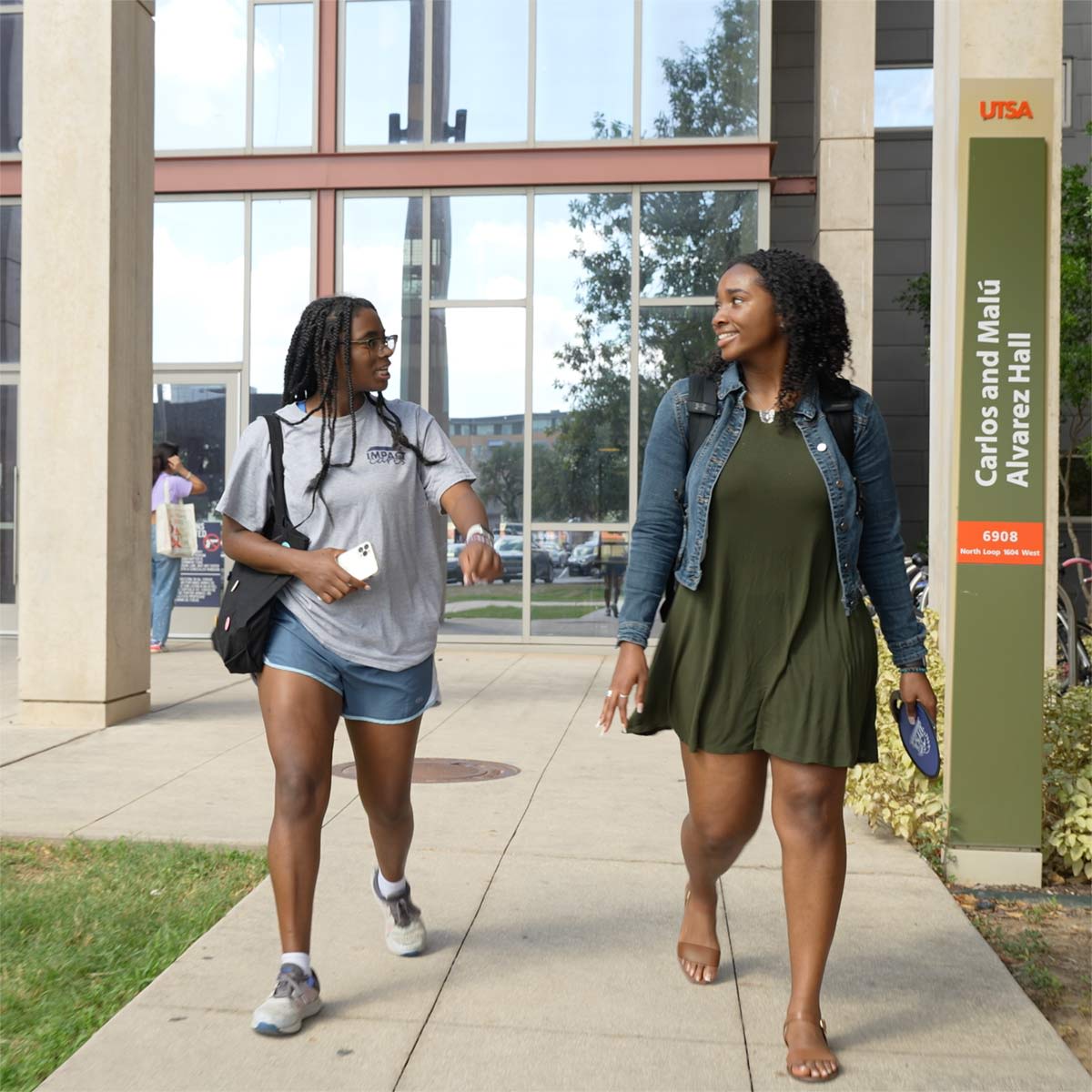 Female students walking out of housing building